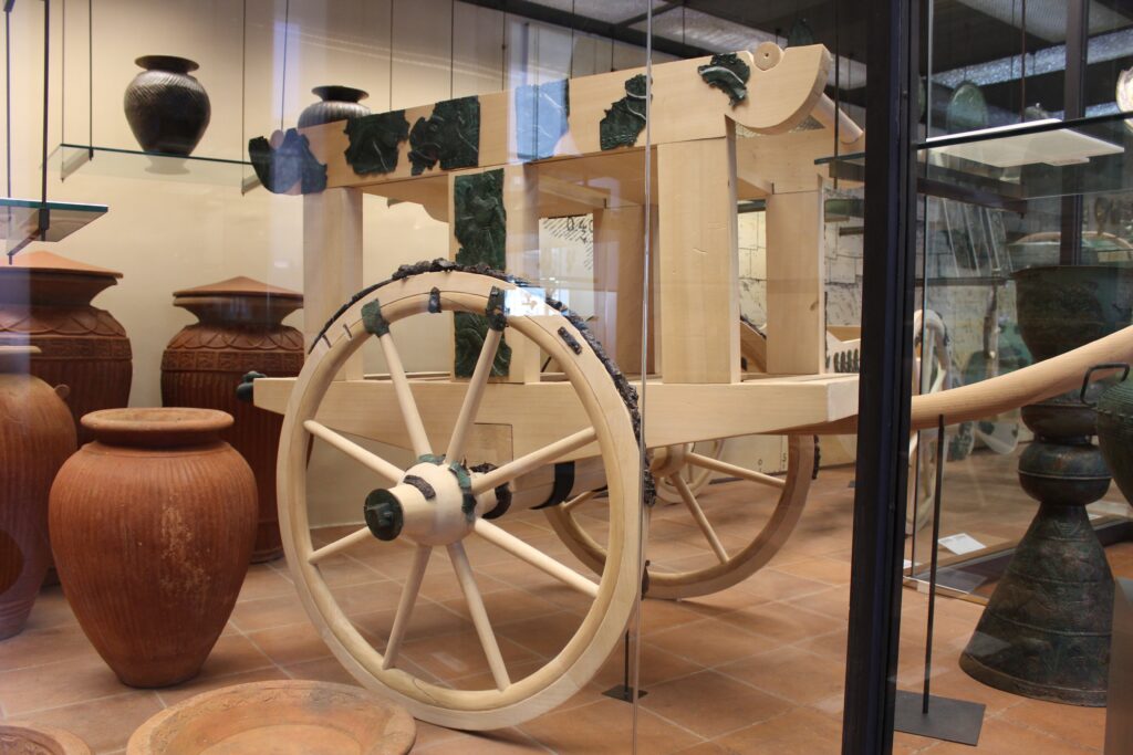 Copper parts of a vehicle have been mounted on a much larger wooden structure in an exhibit at the Vatican Museums